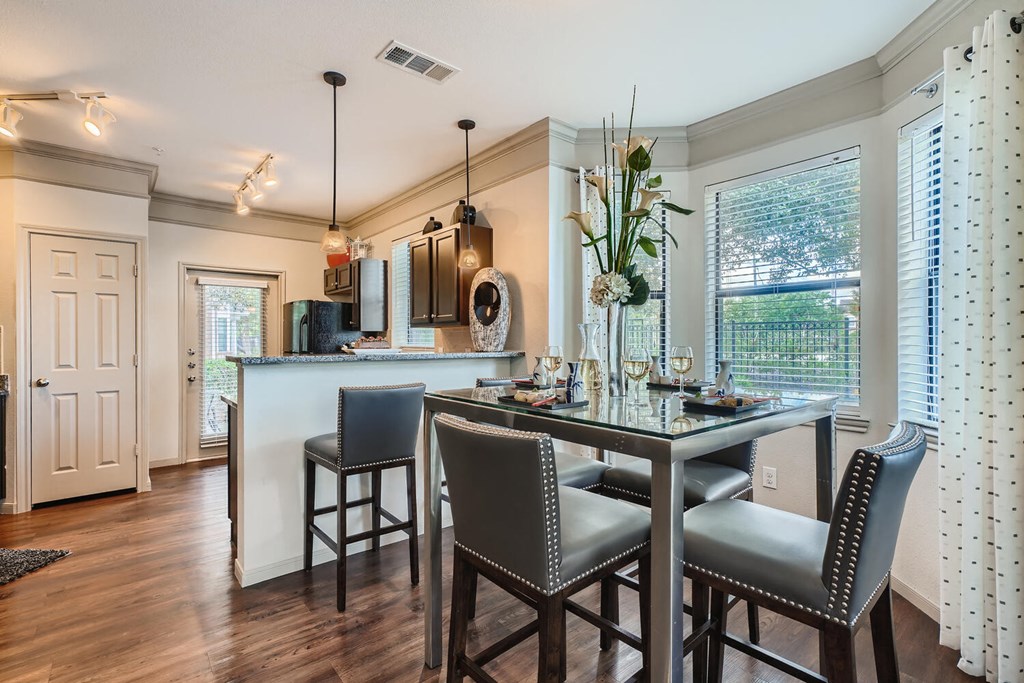 a kitchen with a bar and a table with chairs  at Grand Villas Apartments, Texas, 77494