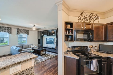 a kitchen and living room with a counter top  at Grand Villas Apartments, Texas, 77494