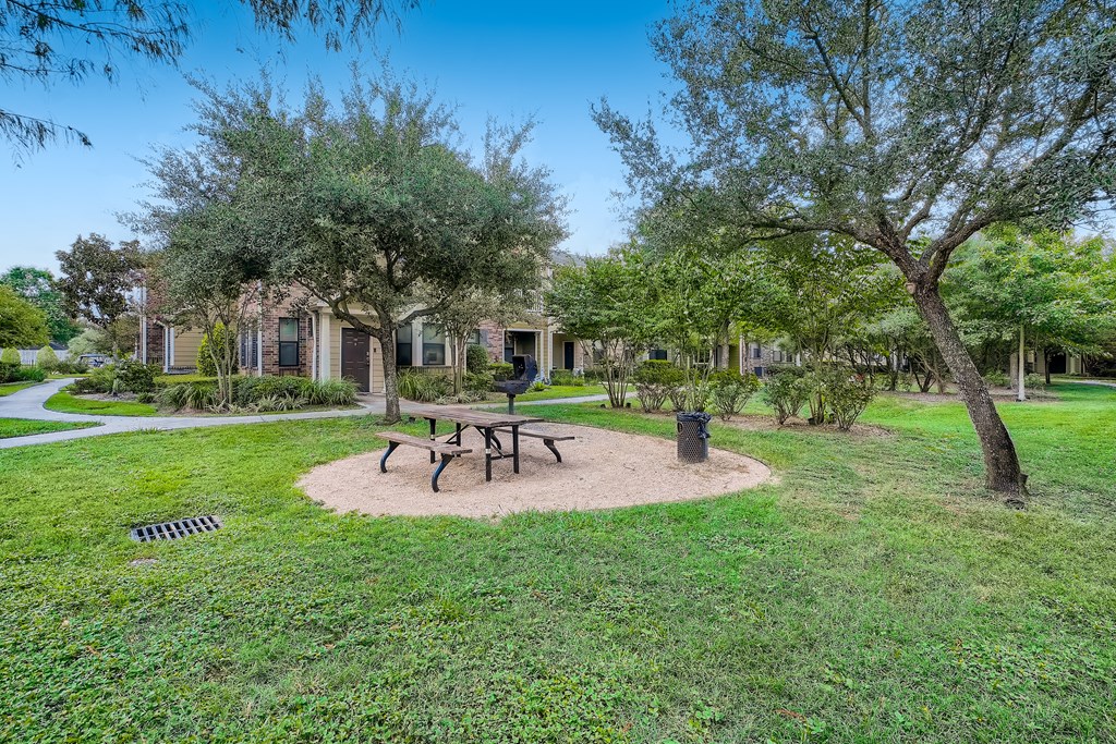 a park with a picnic table and trees in front of our apartments at Grand Villas Apartments, Texas, 77494