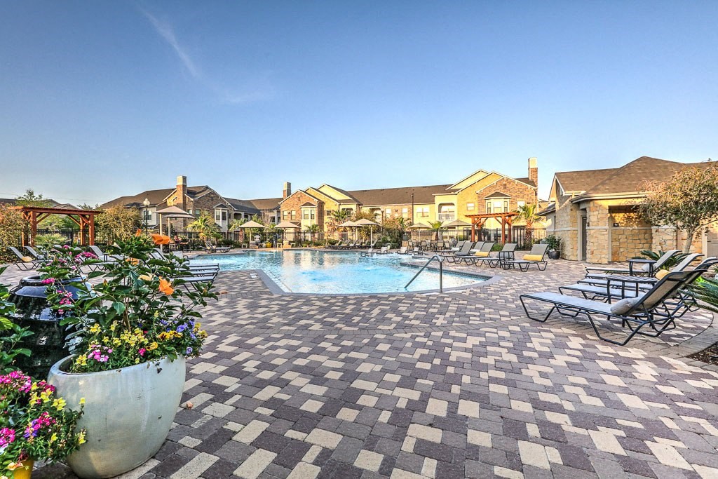 Daytime pool deck and exterior of apartments at Waterstone at Cinco Ranch, Texas, 77450