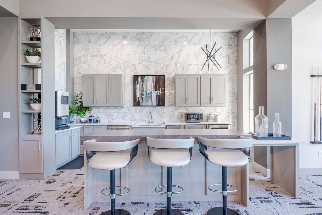 a white kitchen with a bar and white counter tops at Discovery at Craig Ranch, McKinney, Texas
