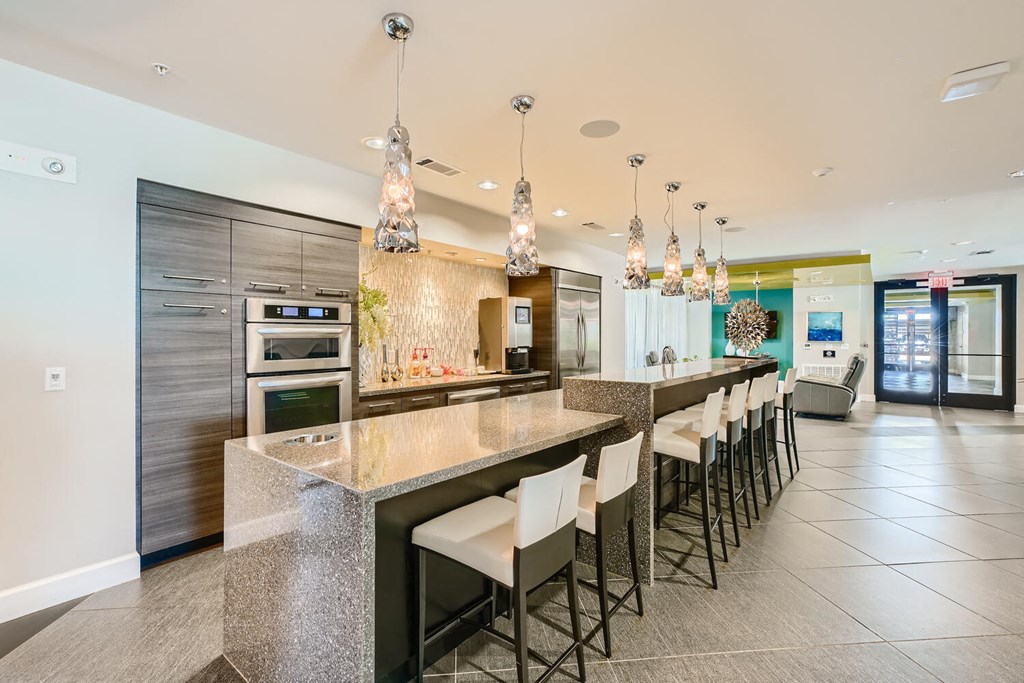 a large kitchen with granite countertops and stainless steel appliances at Imperial Lofts, Sugar Land, 77498