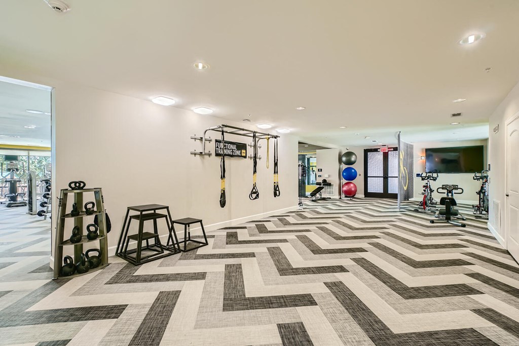 the gym in the house has a checkered floor and weights on the wall at Imperial Lofts, Sugar Land, Texas