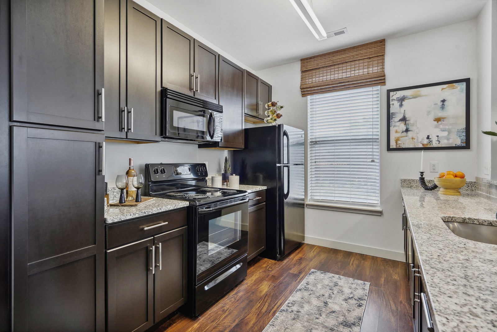 a kitchen with black appliances and granite counter tops