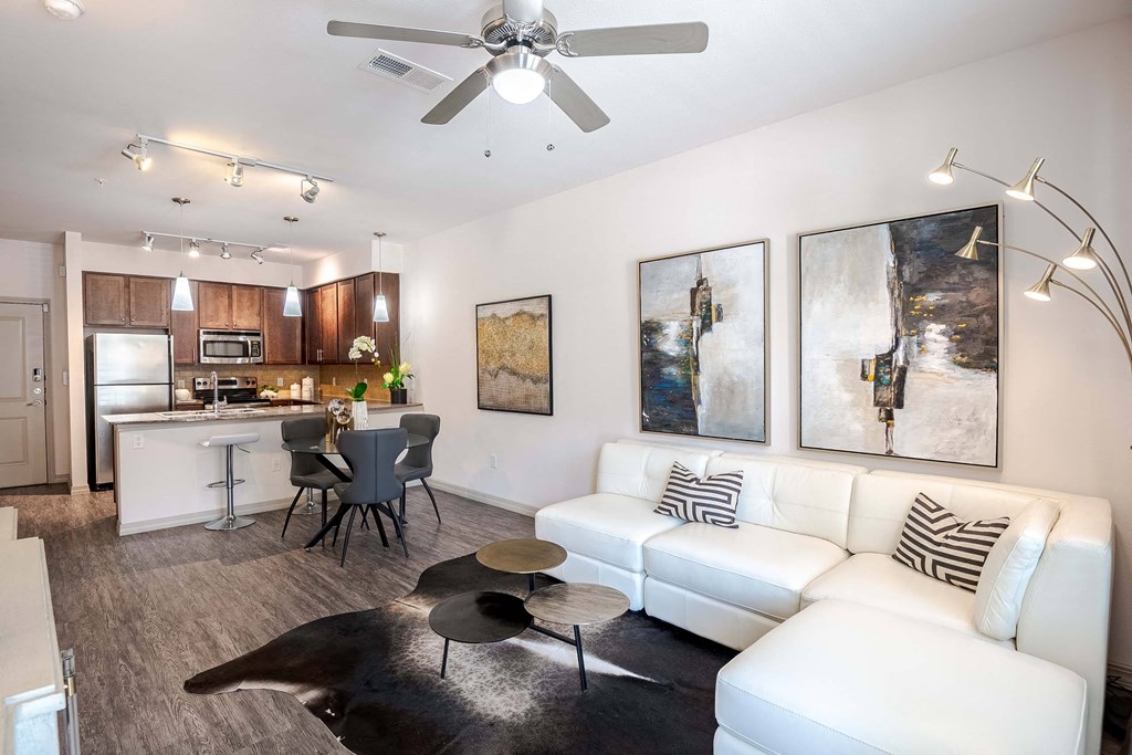 a living room and kitchen with a couch and a table at Discovery at Craig Ranch, McKinney, 75070