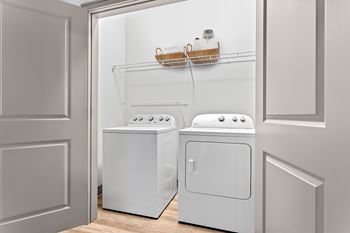 A white dishwasher and dryer in a kitchen.