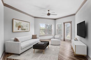 A living room with a white couch, a coffee table, and a painting on the wall.