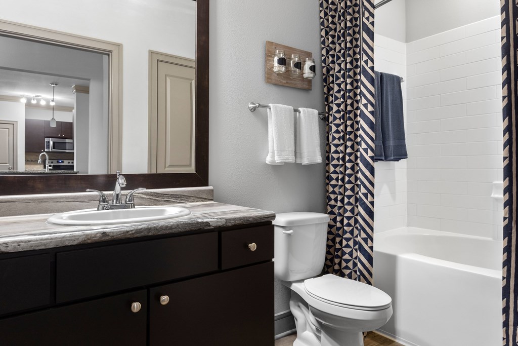 A bathroom with a white toilet and a white sink.