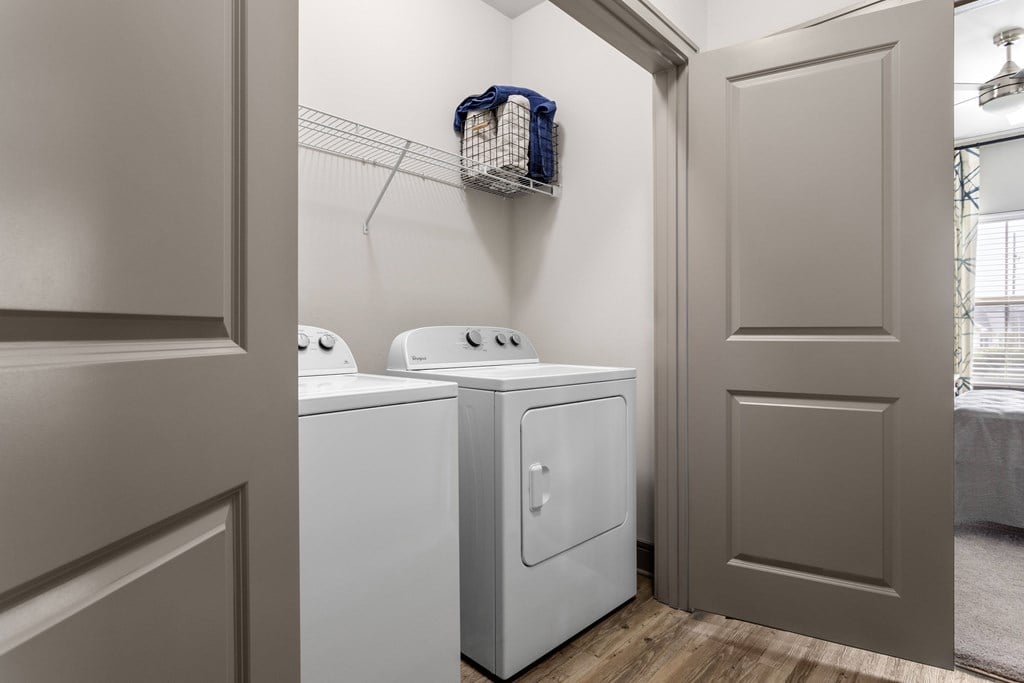 A small laundry room with a washer and dryer.