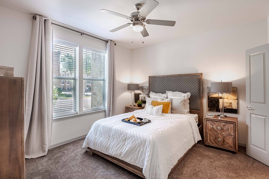 a bedroom with a large bed and a ceiling fan at Discovery at Craig Ranch, McKinney, Texas