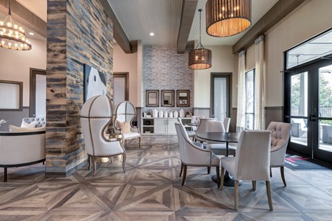 Elegant clubhouse lounge with wood accent wall at Adara Overland Park Apartments, Overland Park