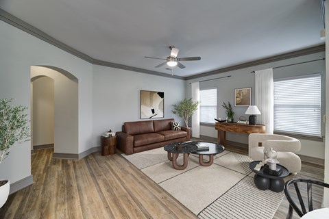 A living room with a brown couch and a coffee table.