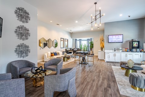 A modern living room with grey chairs and a white sofa.