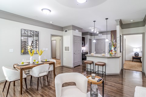 A modern kitchen with a dining table and chairs.