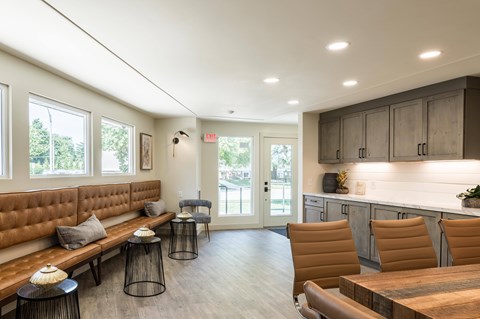 A modern living room with a brown sofa and a wooden table.