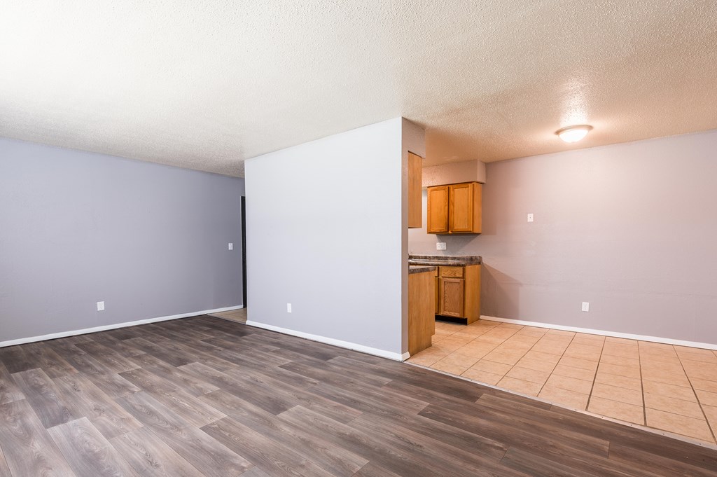 A room with a kitchenette and a wooden floor.at 3TEN, Springfield, 62704