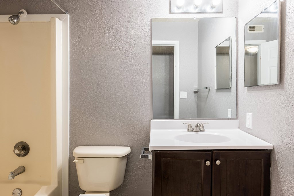 A white sink is on a countertop next to a toilet.at 3TEN, Illinois