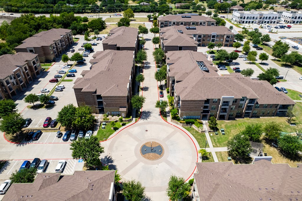 an aerial view of a neighborhood with houses and buildings and a circle in the middle at Discovery at Craig Ranch, McKinney, 75070