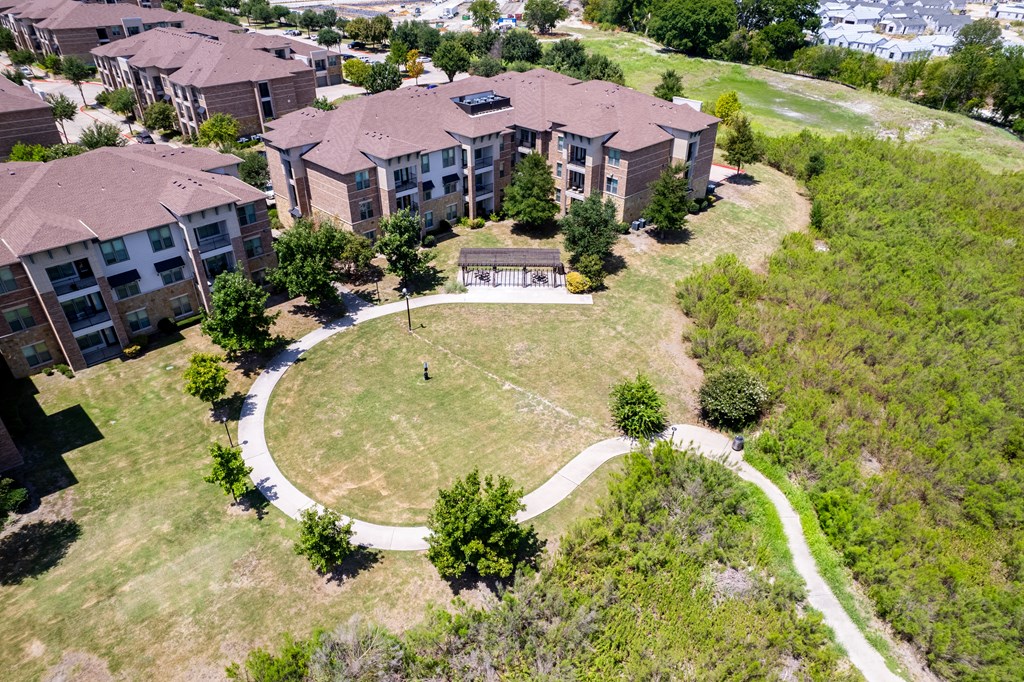 an aerial view of a building with a yard and a pathway at Discovery at Craig Ranch, Texas, 75070