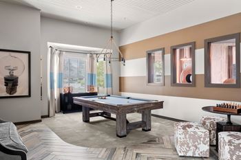 A room with a pool table and a chess board.