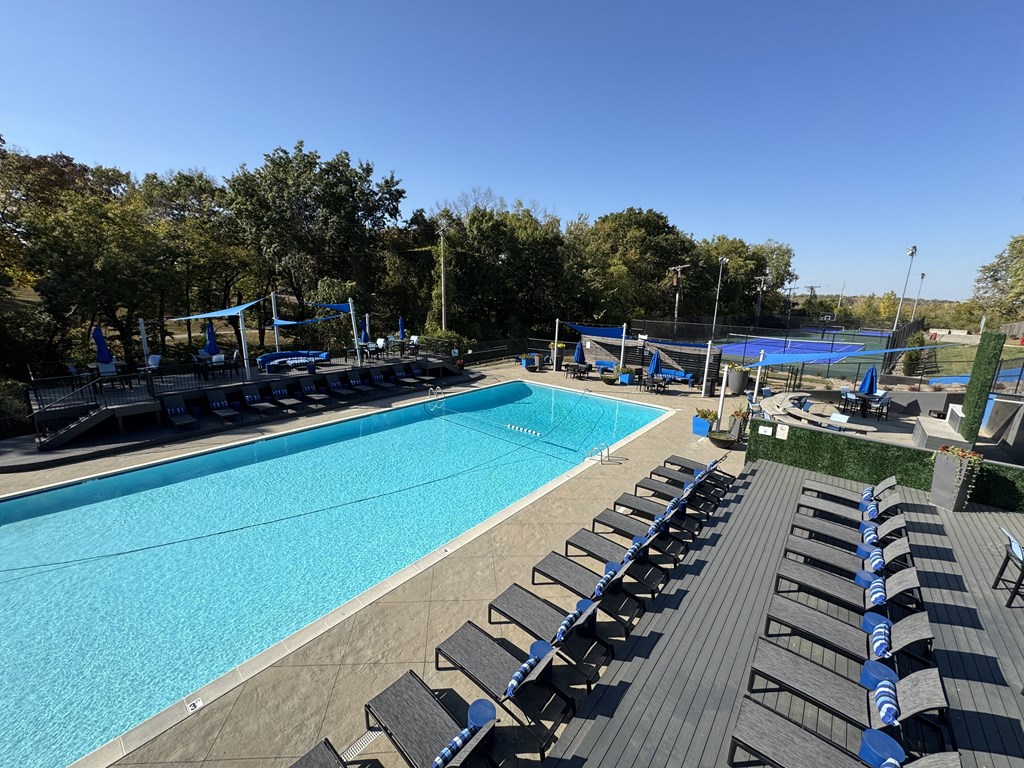 an aerial view of a swimming pool with lounge chairs at The Boulevard, Roeland Park, KS