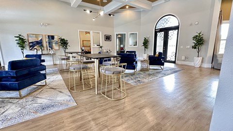 a living room with blue couches and chairs and a table with chairs at Waterstone at Cinco Ranch, Katy, TX, 77450