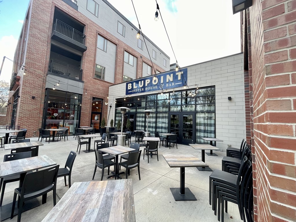 an outdoor patio with tables and chairs outside of a restaurant