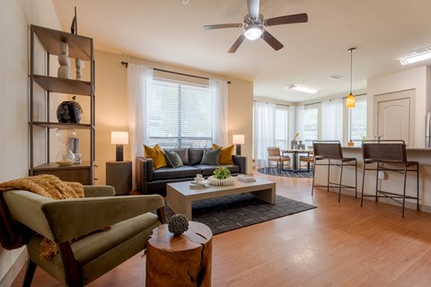 A living room with a green chair and a brown coffee table.