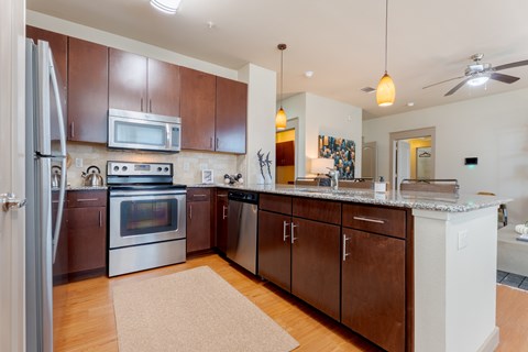 A kitchen with brown cabinets and a white refrigerator.