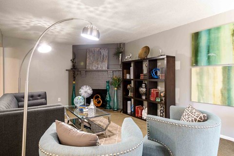 Modern living room with decorative shelving and seating at London House Apartments, Lenexa, KS