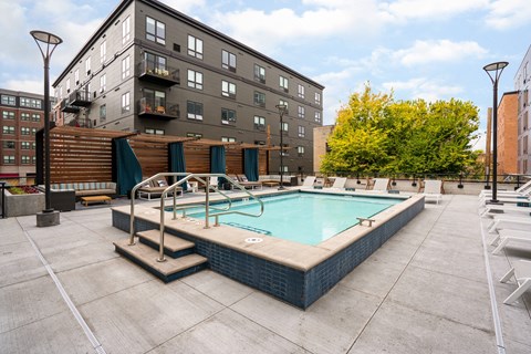 Rooftop pool with deck chairs and cabana structure at Marquee Apartments, Minneapolis, MN 55403