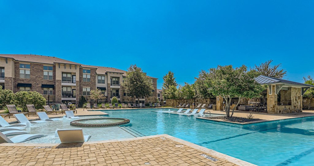 our apartments offer a swimming pool with chaise lounge chairs at Discovery at Craig Ranch, McKinney, 75070