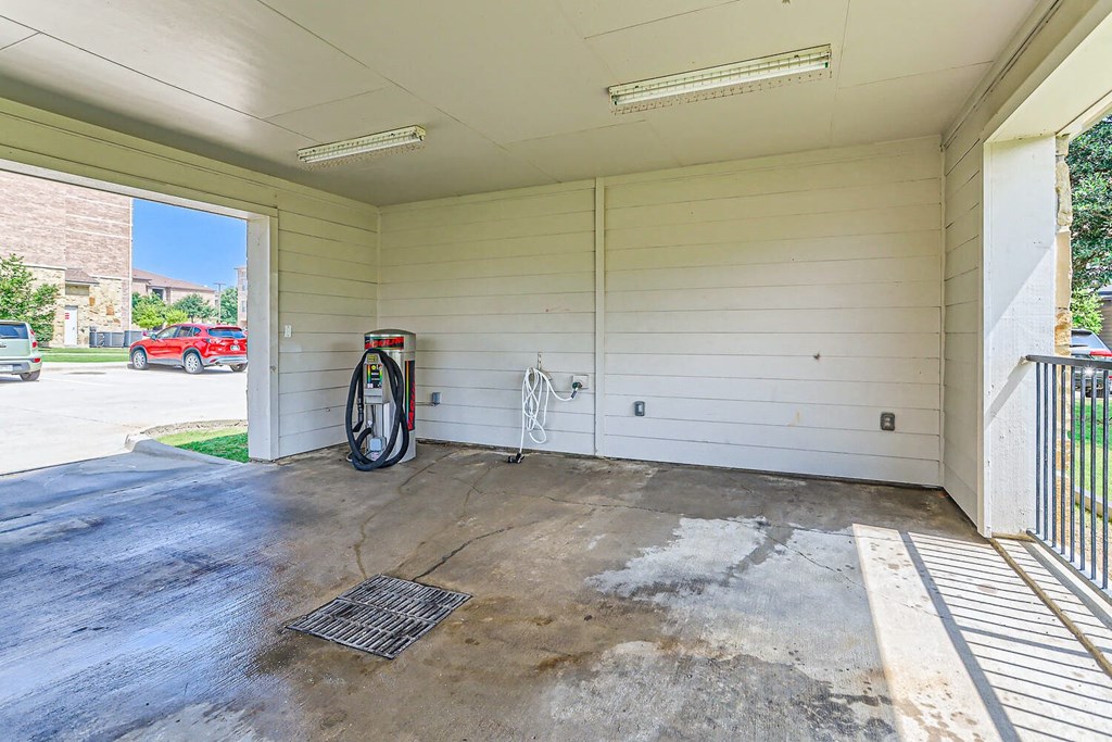 a covered porch with a gas pump on the side of a building at Discovery at Craig Ranch, Texas