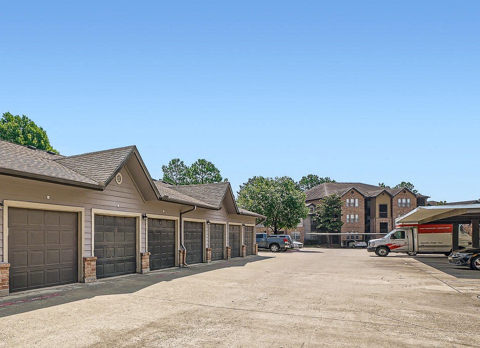 a parking lot with a row of garage doors at River Pointe, Conroe, TX