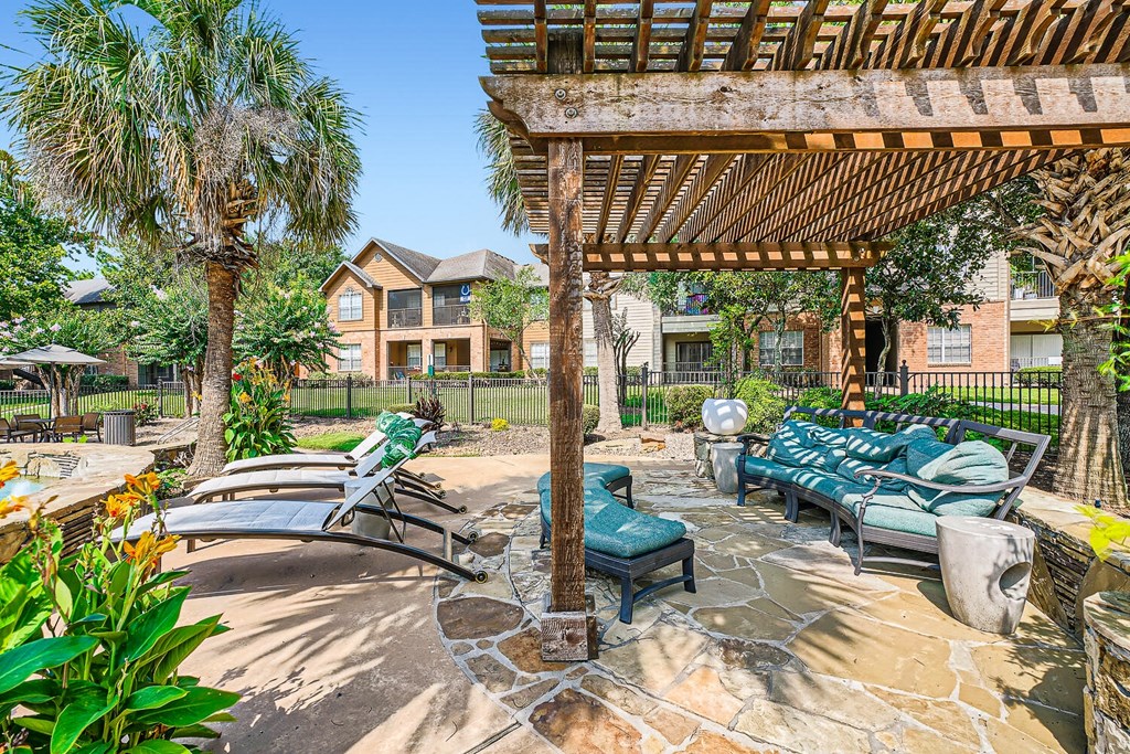 a patio with lounge chairs and a pergola at River Pointe, Conroe, TX, 77304