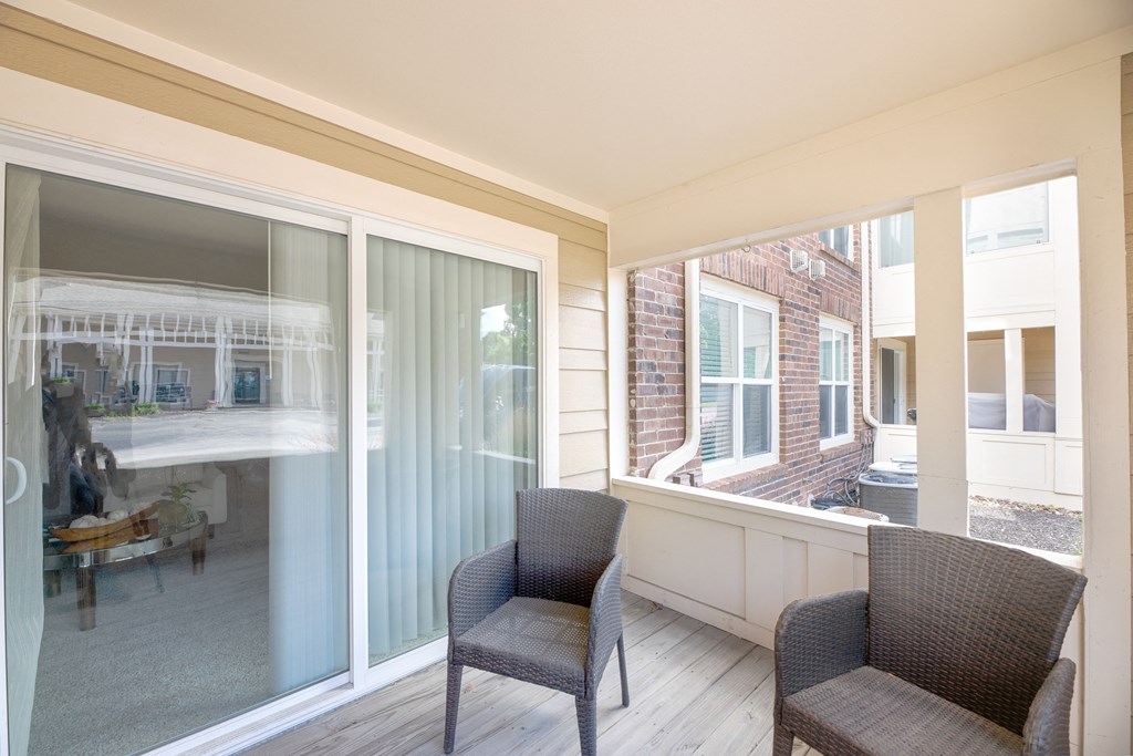 a living room with two chairs and a large window  at Butternut Ridge, North Olmsted, 44070