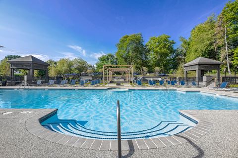 a swimming pool with chairs and gazebos at the resort at governors island