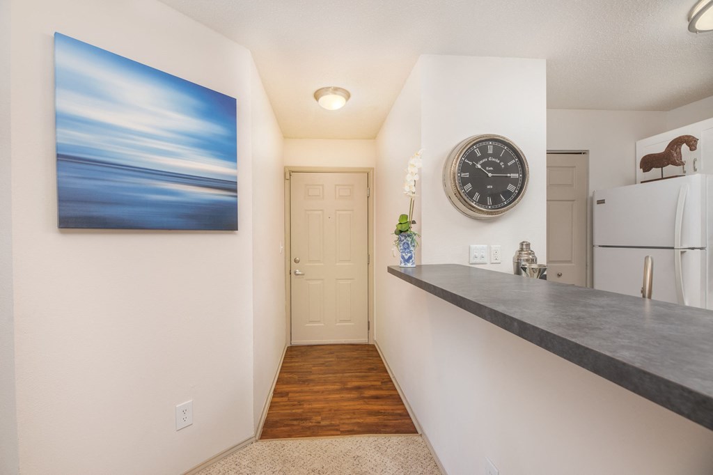 a kitchen with a counter and a clock on the wall and a refrigerator  at Butternut Ridge, Ohio