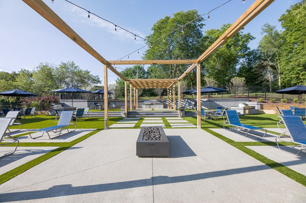 a large patio with lounge chairs and a fire pit  at Butternut Ridge, North Olmsted, OH