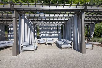 a group of lounge chairs under a pergola