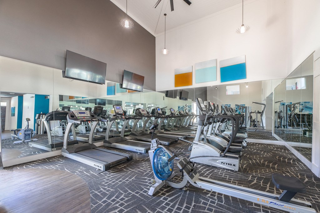 a gym with cardio machines and a glass walled room with cardio equipment  at Butternut Ridge, North Olmsted, OH