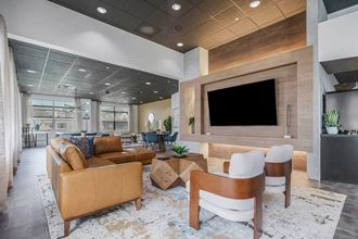 a living room with a couch and a television at CityView, North Kansas City, MO