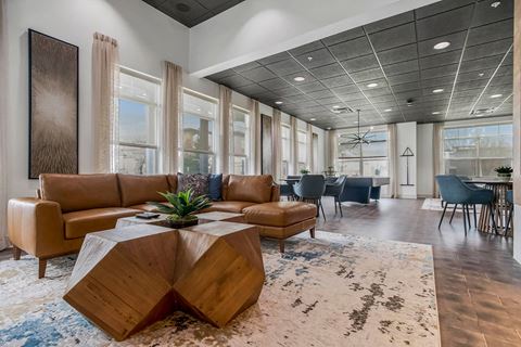 a lobby with couches and a table on a rug