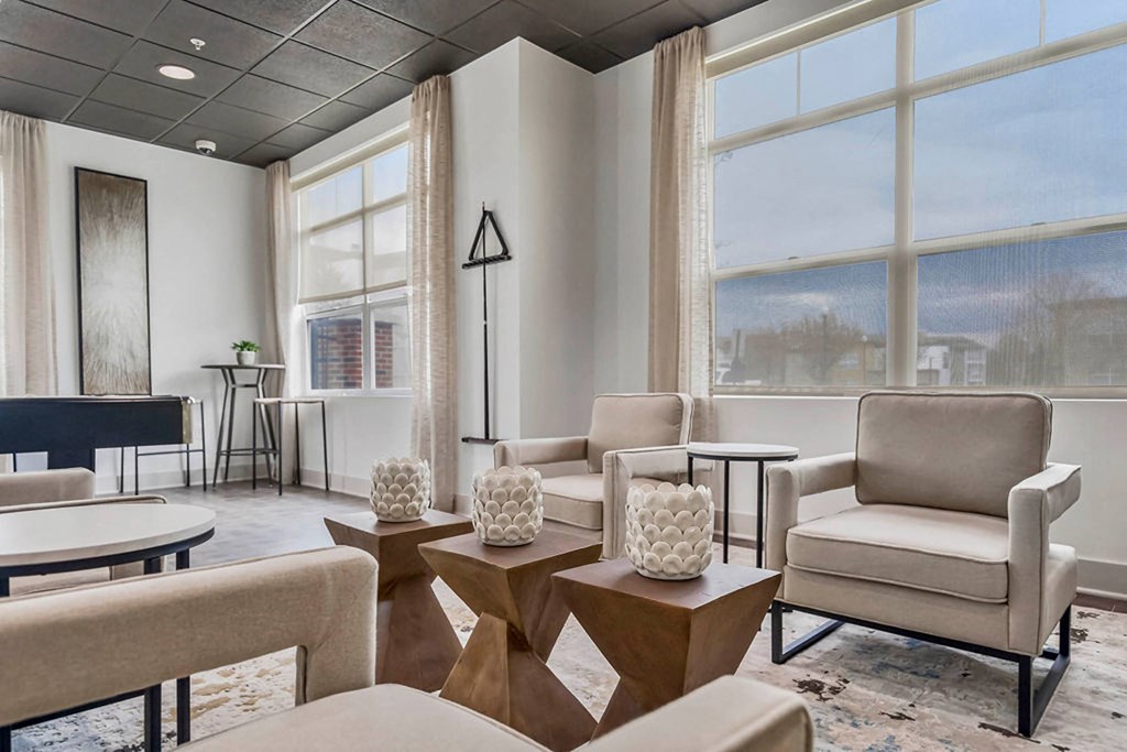 a waiting room with chairs and tables and large windows at CityView, North Kansas City