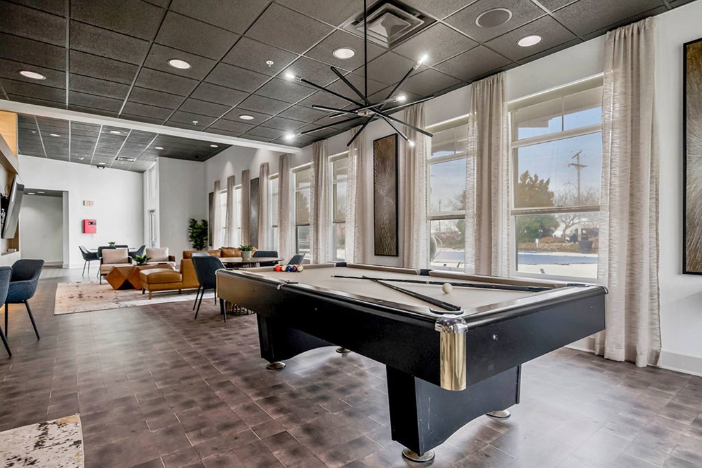 a game room with a pool table and windows a game room with a pool table and windows at CityView, North Kansas City, Missouri