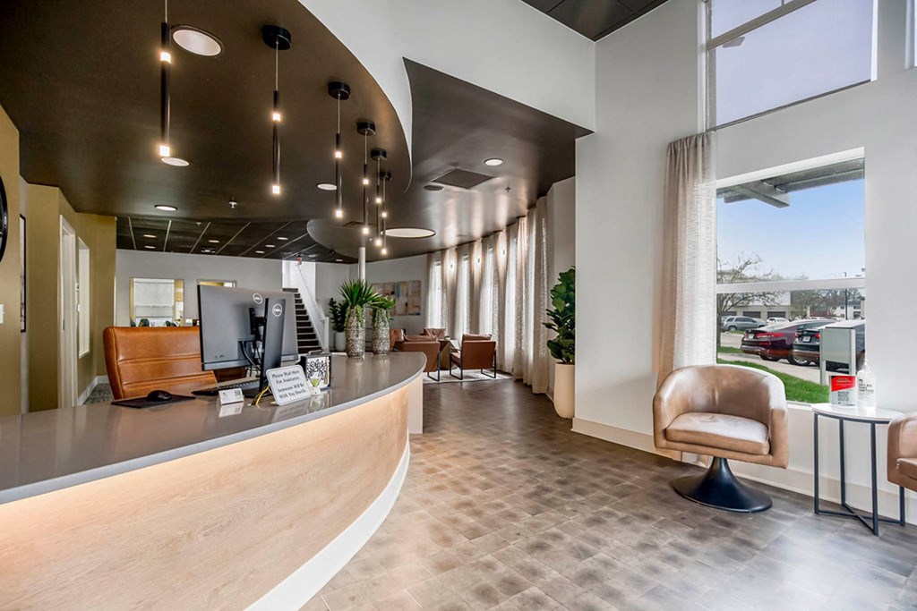 a lobby with a reception desk and a large window at CityView, North Kansas City, Missouri
