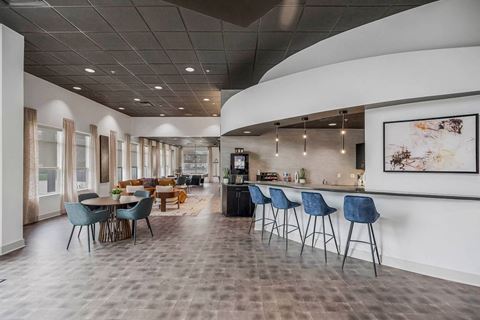 a large lobby with tables and chairs and a bar at CityView, North Kansas City, 64116