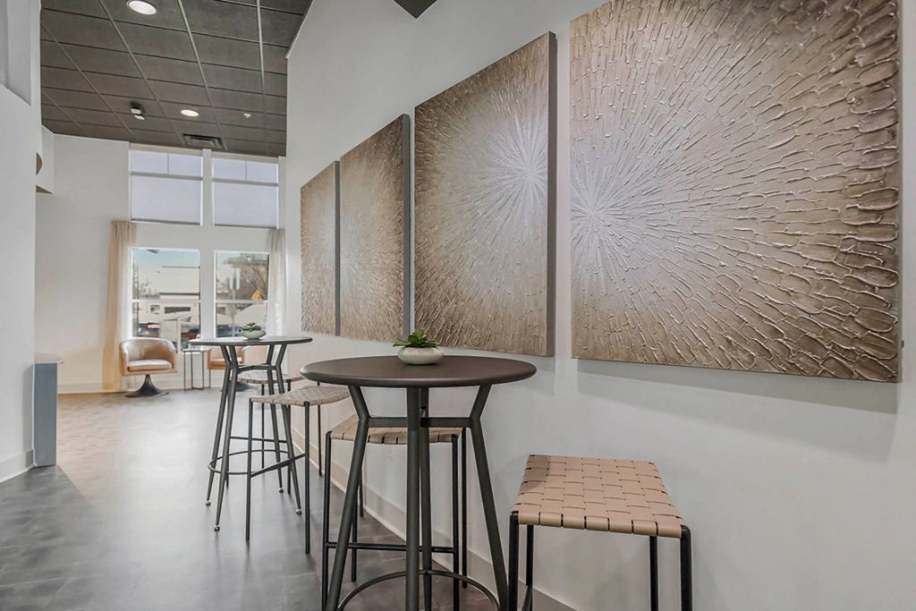a seating area with stools and a table in a lobby at CityView, North Kansas City, MO