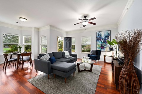 a living room with a couch and a ceiling fan