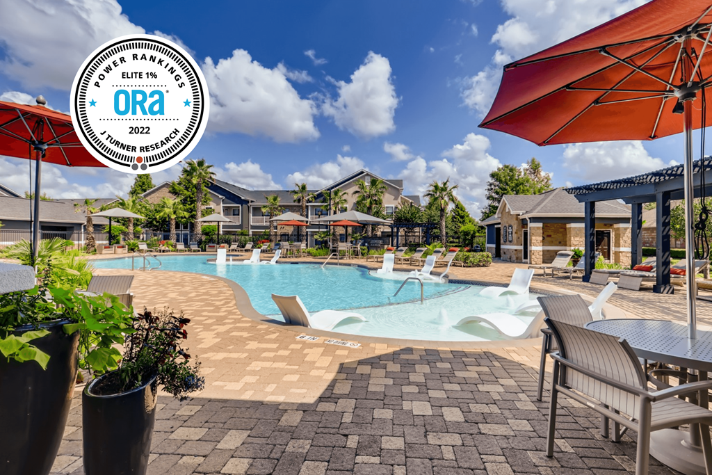 a swimming pool with chairs and umbrellas at the resort